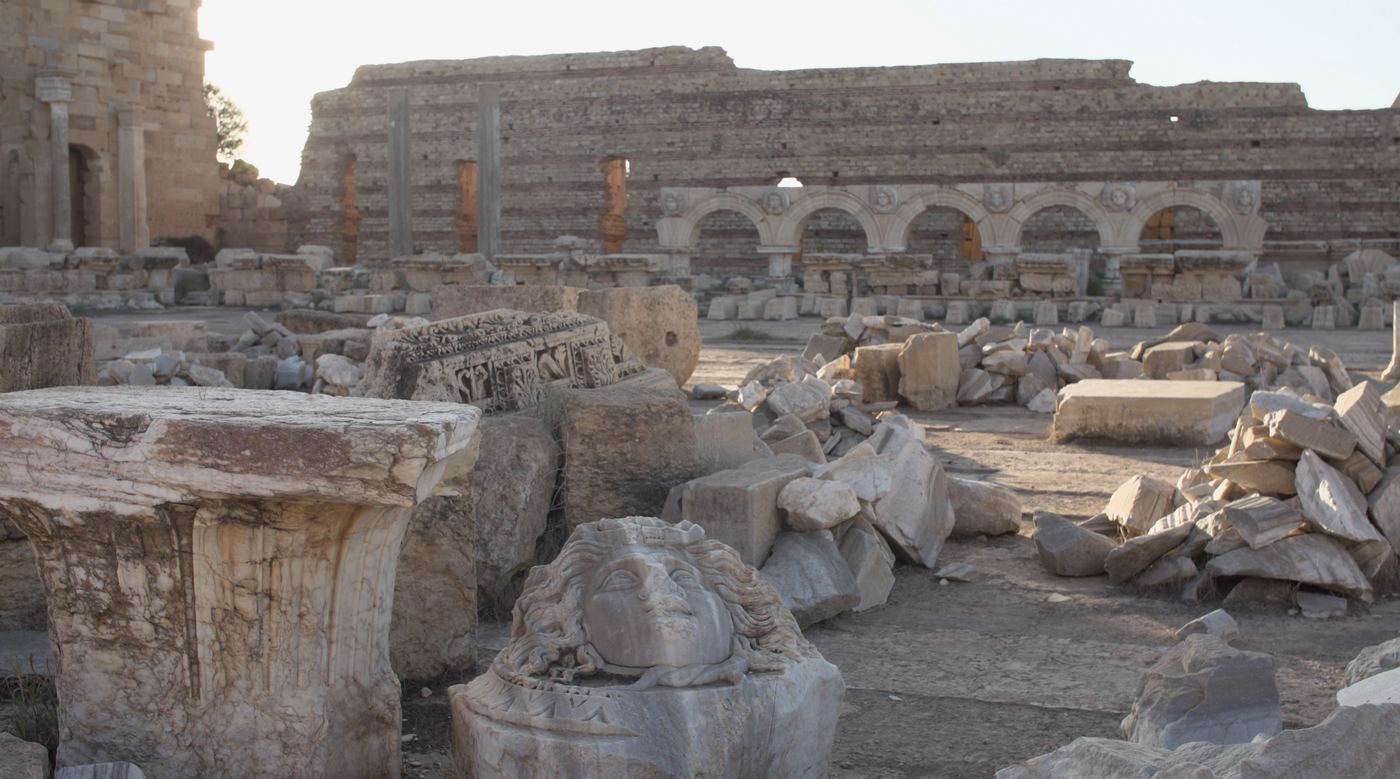 The Severan Forum at Leptis Magna, with fallen marble and a carved Medusa head in the foreground